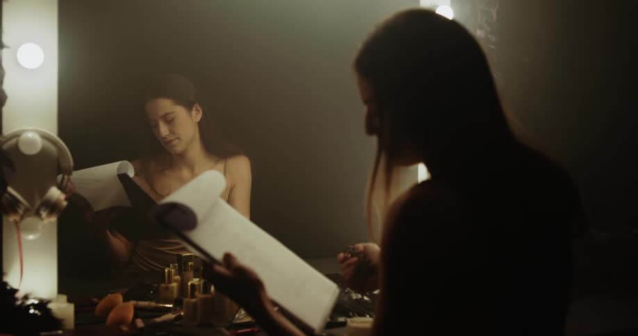 A woman is looking at herself in the mirror