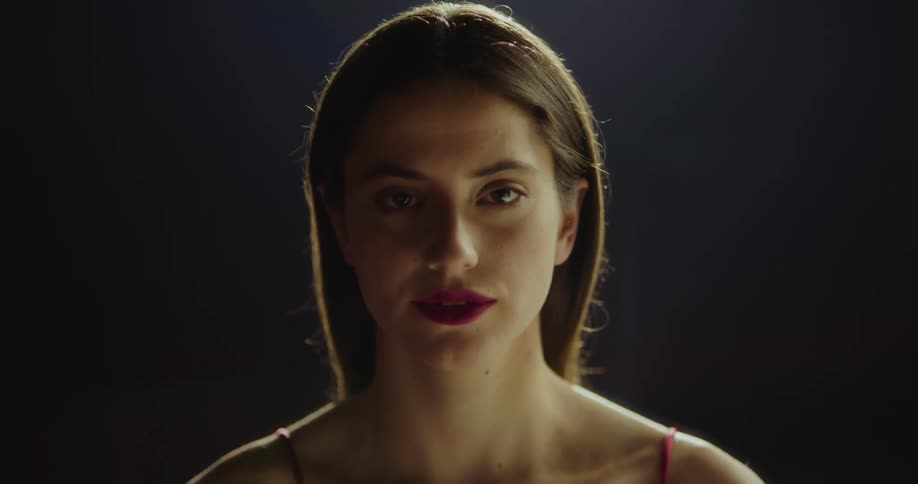 A teenage girls opens her eyes and takes a deep breath and looks ahead