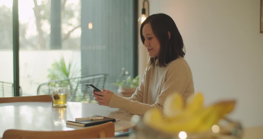 A woman texting on a smartphone