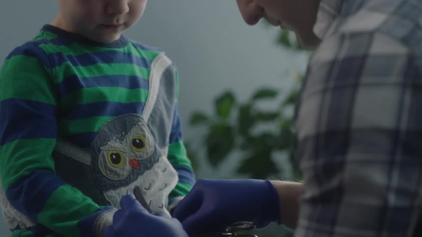 A doctor checking out a child in an exam room