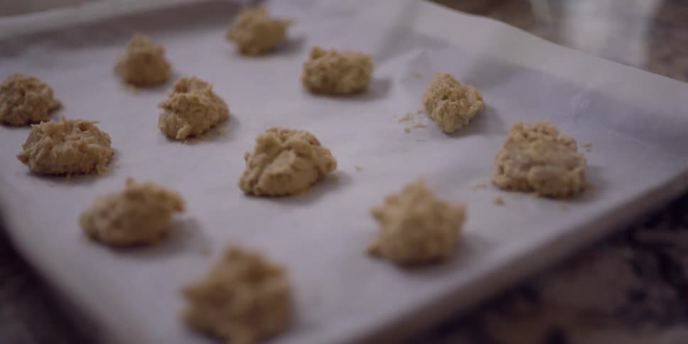 Cookie dough is placed on a pan and is on a table