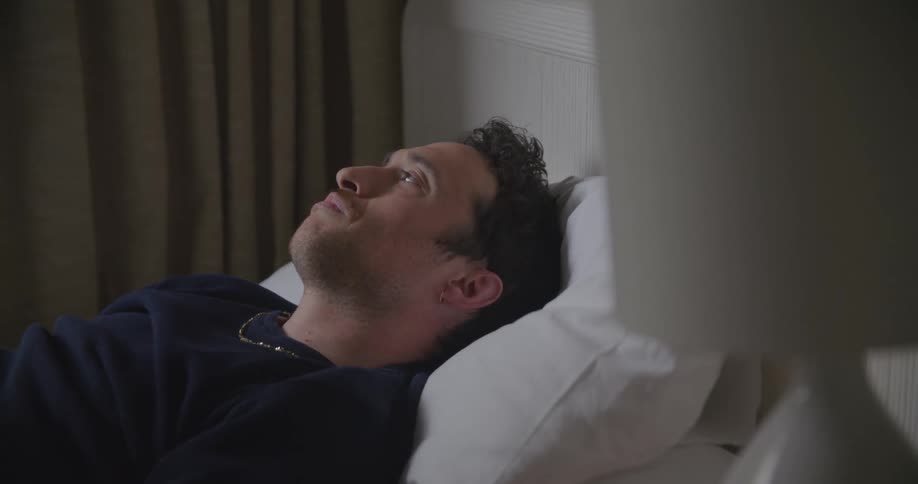 A man laying on a pillow