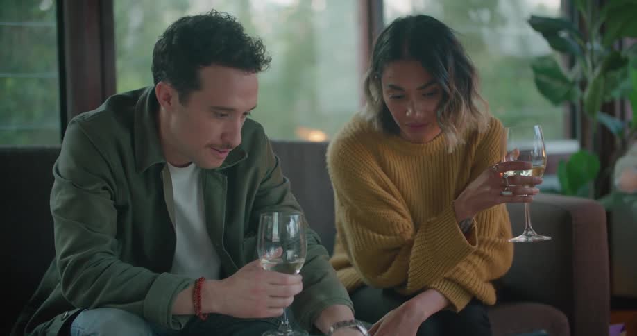 Two people drinking and using a laptop