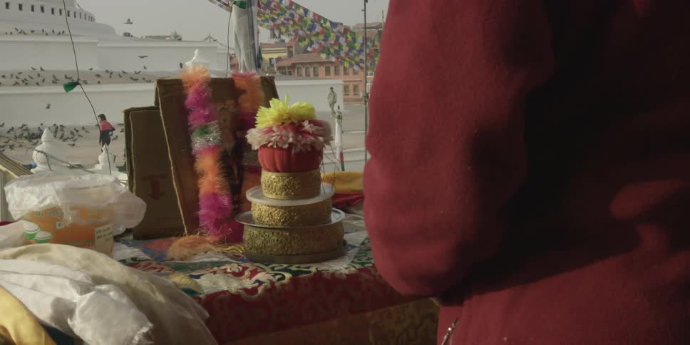 A person is standing near a table with fabric on it