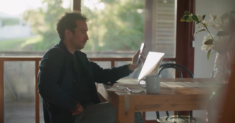 A man using a phone at a table