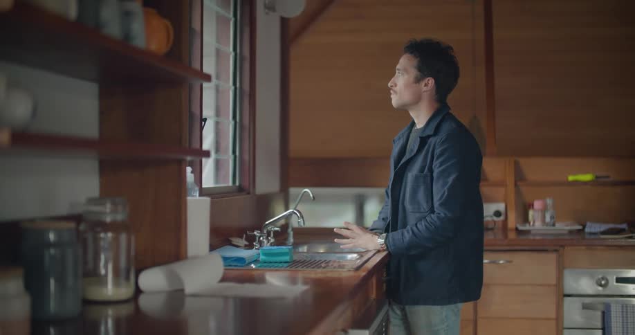 A man standing in a room thinking