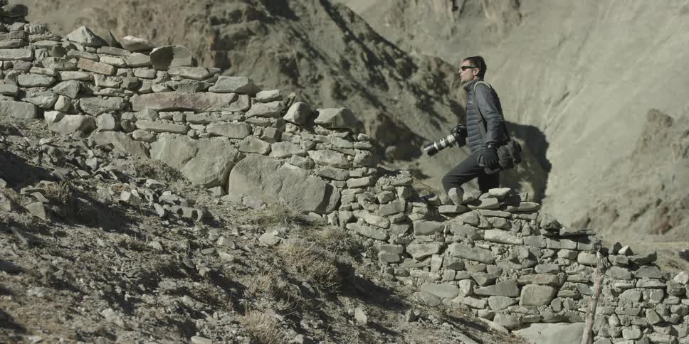 A man walks up a stone path