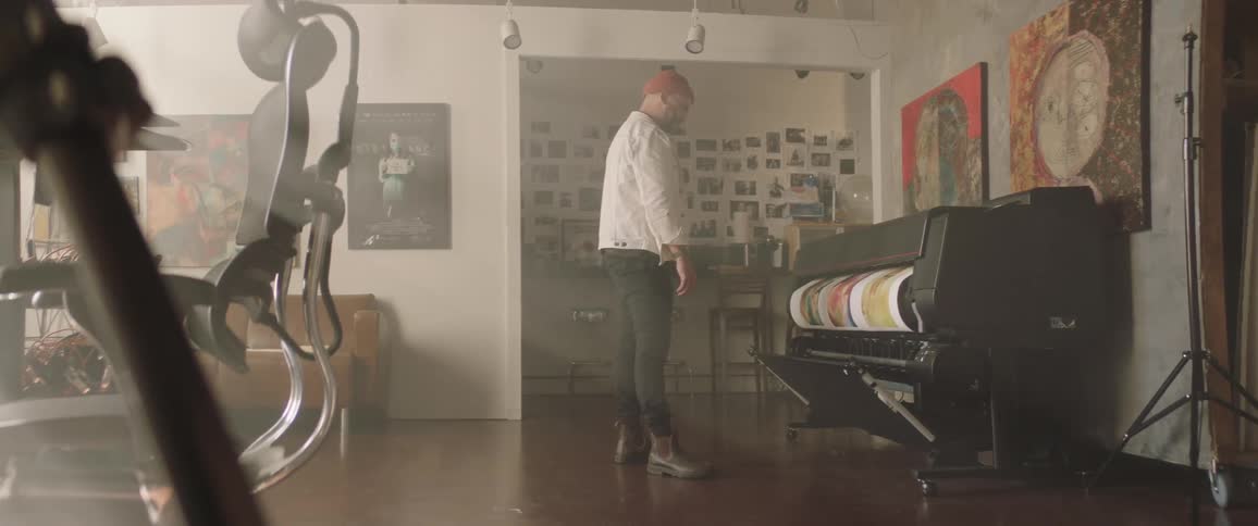 A designer watching a printer print art