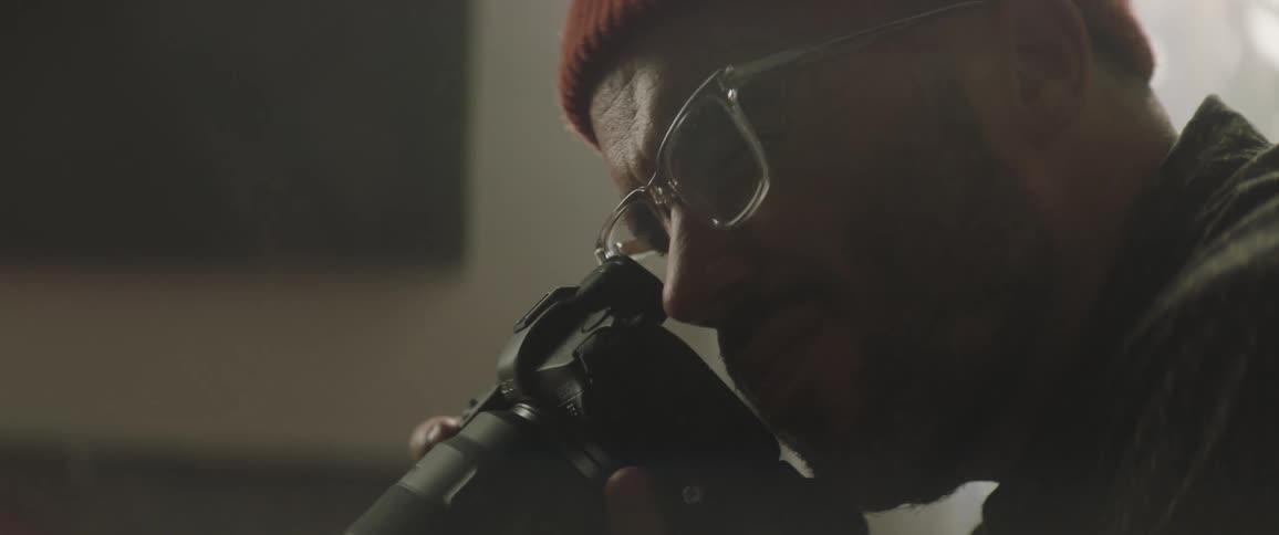 A man is photographing something with a large camera