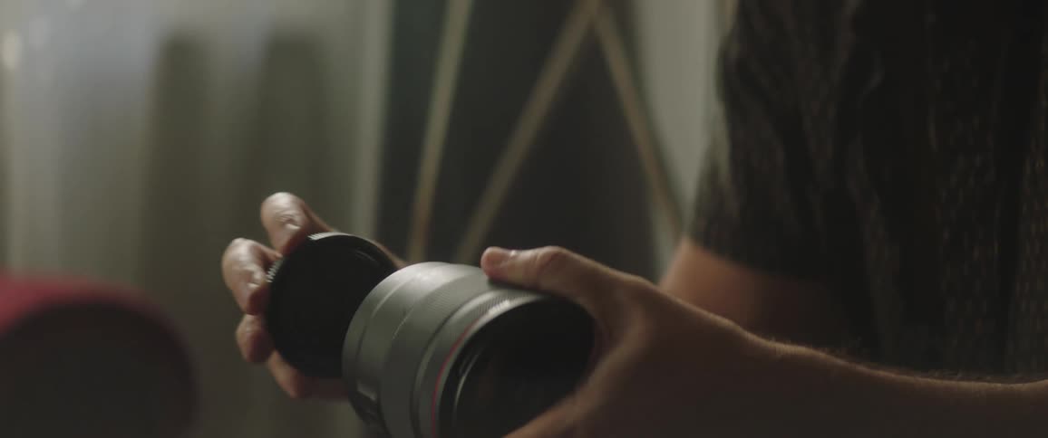 A man putting together a photography camera