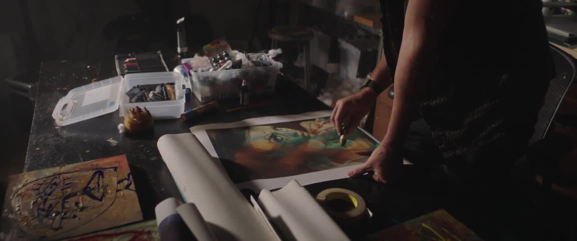 A man grabs some paint to complete an art project