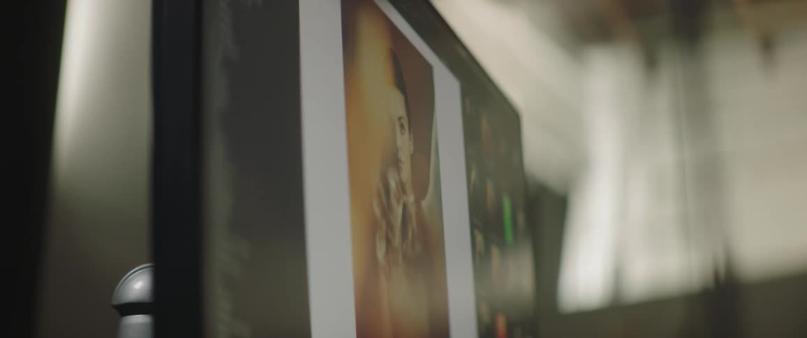 A photograph of a female model is displayed on a computer monitor
