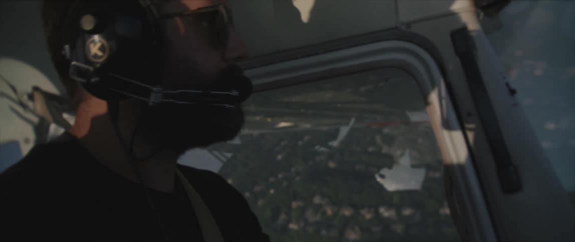 A man is flying a plane in the sky