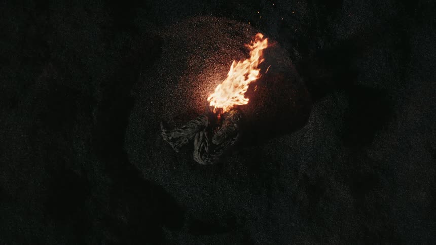 A fire with smoke and embers burning
