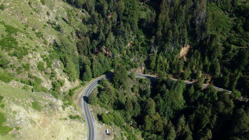 A car drives on a mountain road