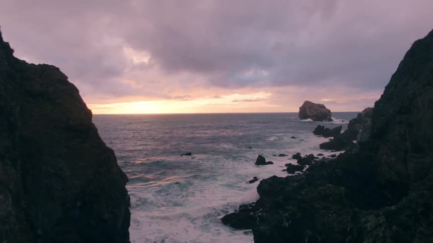 Ocean waves crash into rocks