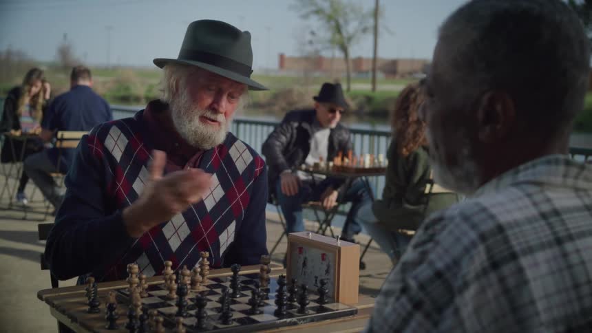 Two men playing chess outdoors