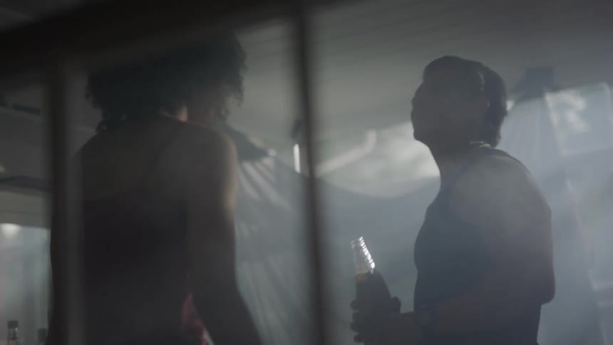 Man and woman dance and drink alcohol from a bottle