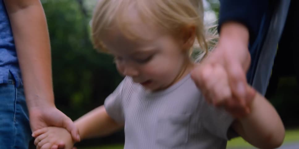Mom son and daughter holding hands and running and stomping outside