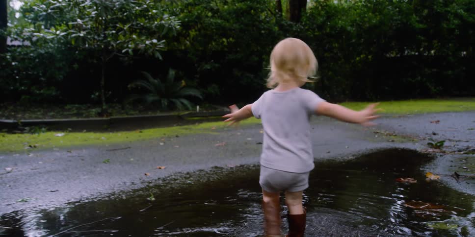 A child playing in a puddle