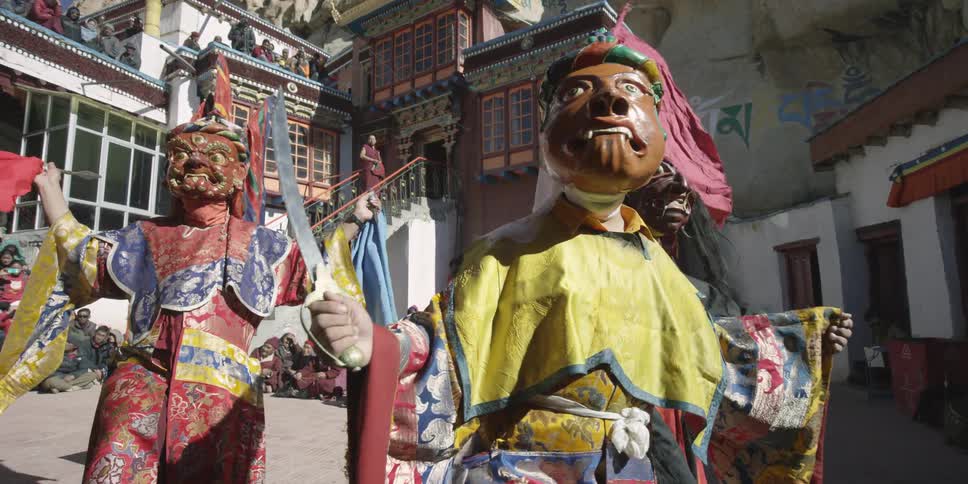 People wearing colorful masks and costumes