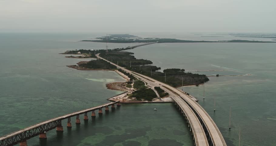 An aerial view of a road over some water
