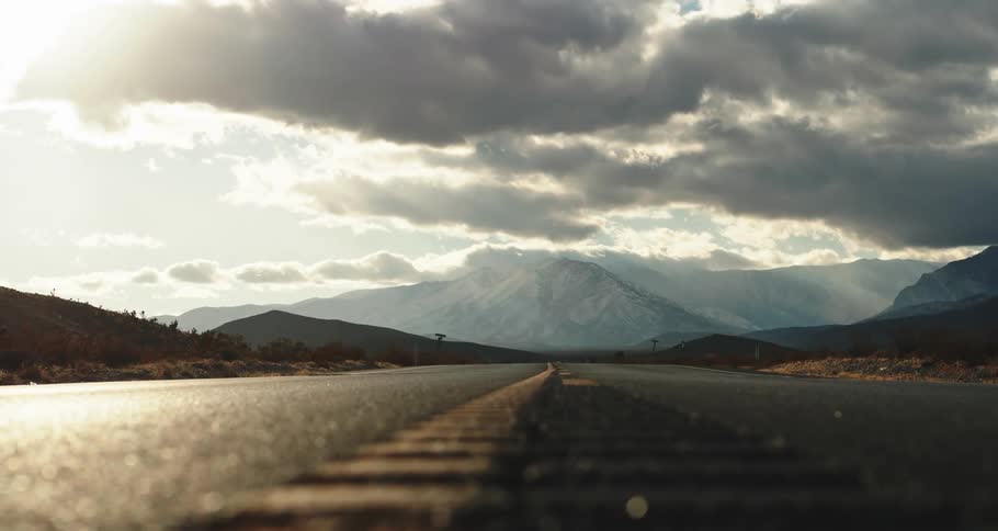 A view of a landscape with mountains at the end