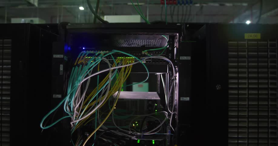 Multicolored cables hanging out from a server rack