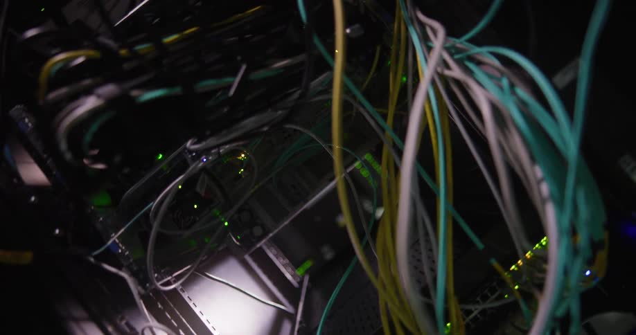 A computer is spinning with wires and lights coming from it