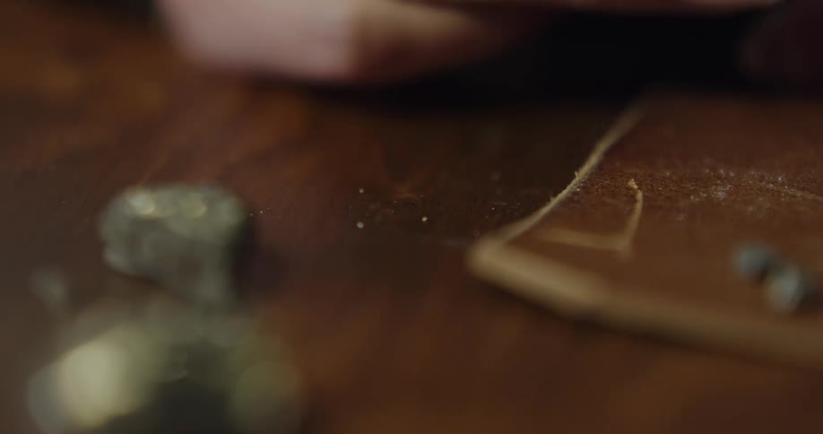 A jeweler picks up settings