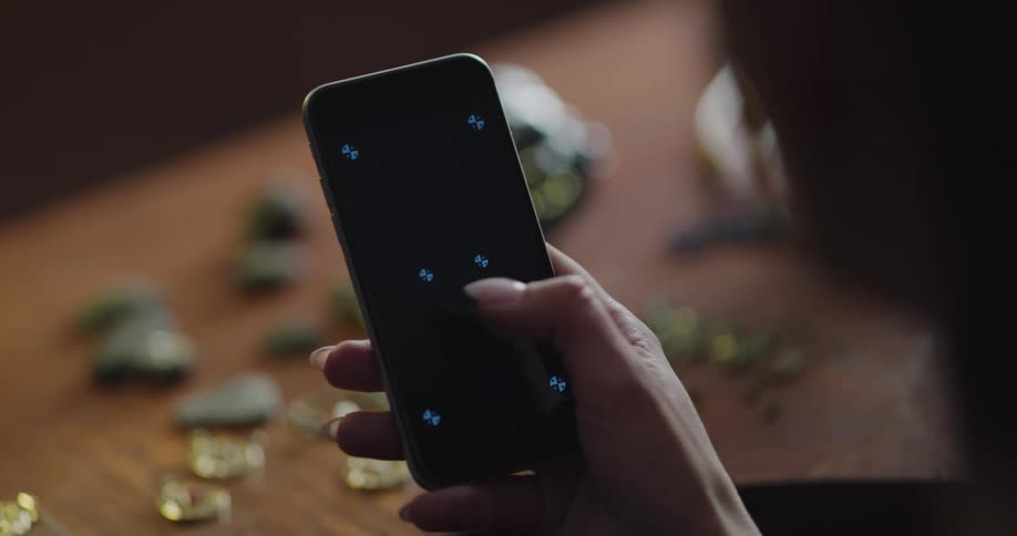 Woman taps the screen of a mobile phone with her thumb