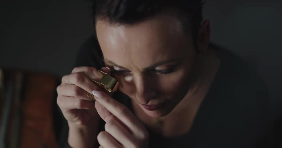 A jeweler examines a piece