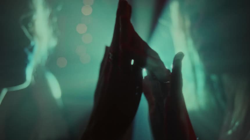 Two people holding hands