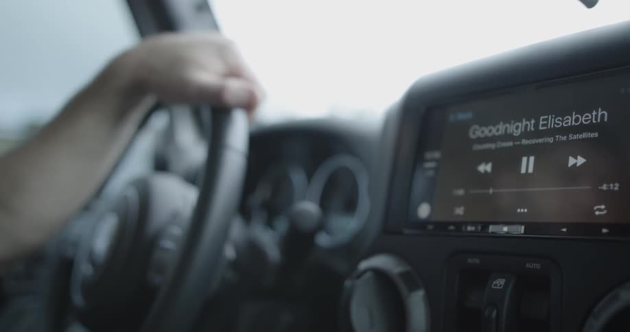 Close up of the dashboard of a car as a person drives