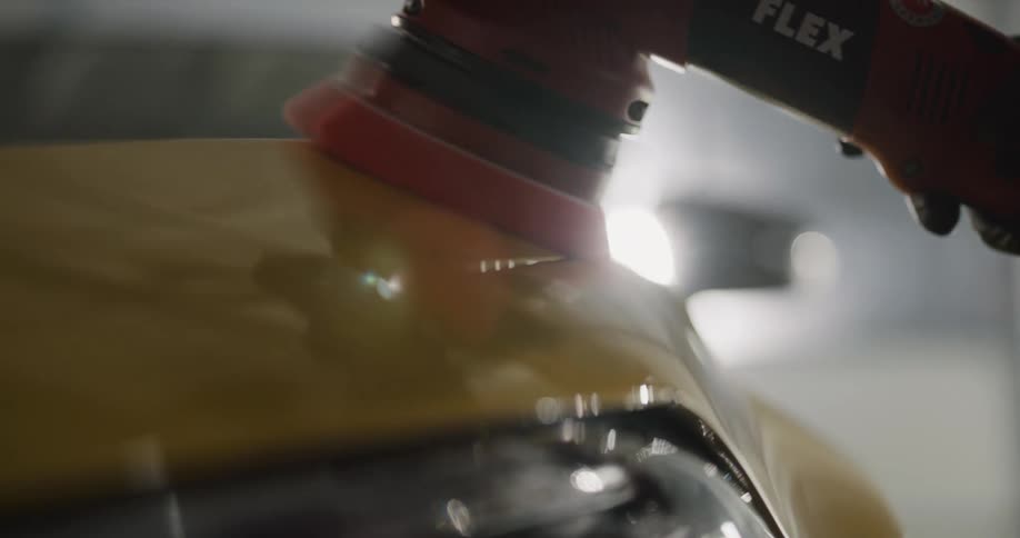 A person is washing a car with a machine