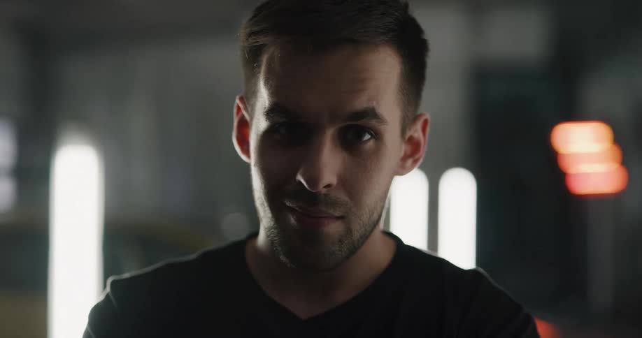 A man is standing inside a building and smiling