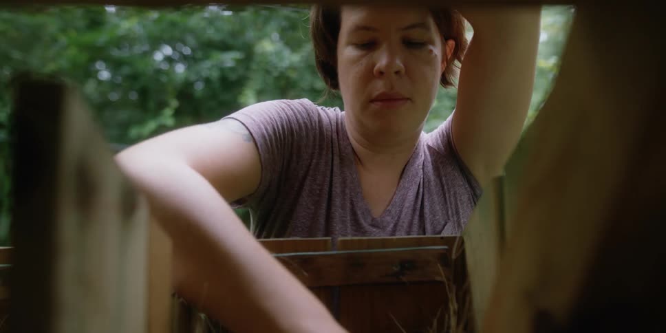 A woman unloading things from a box outdoors