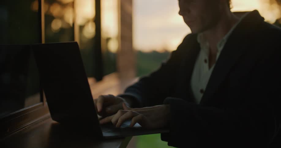 A man sitting at a laptop typing