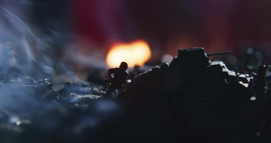 Toy soldiers and other military toys surround a burning fire