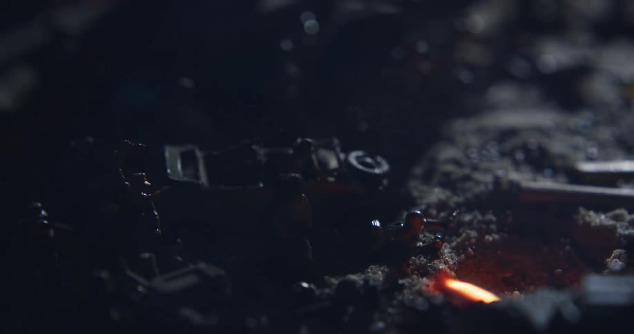 Flame burns near a collection of military toys