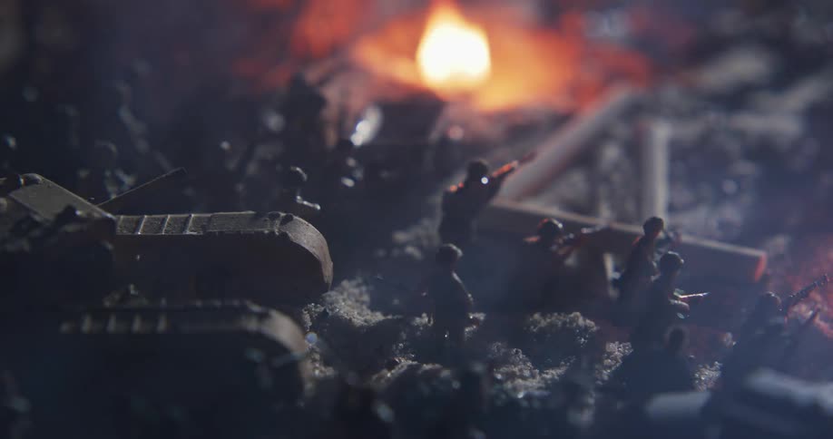 Fire burns near a collection of military toys
