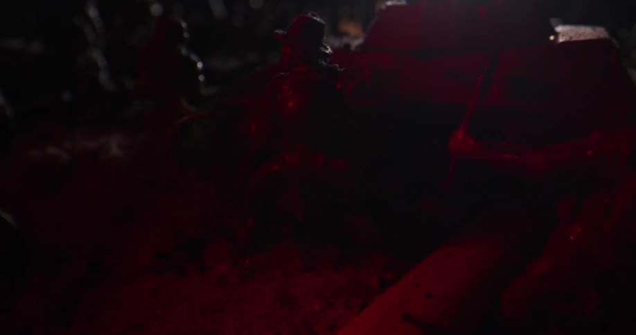 Light flashes and glows red on arranged toy soldiers and tank