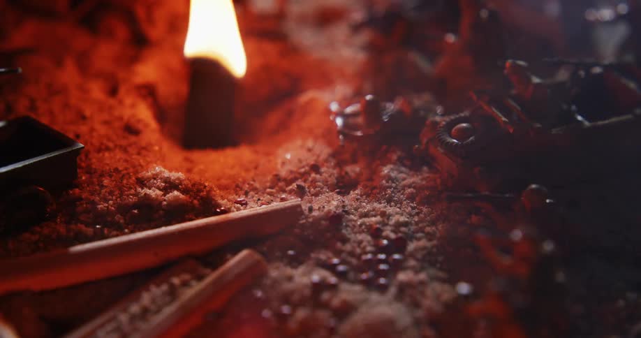 Army men toys and wagons in dirt surround a glowing flame