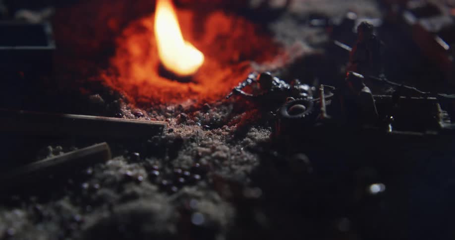 Fire burns next to the military toys