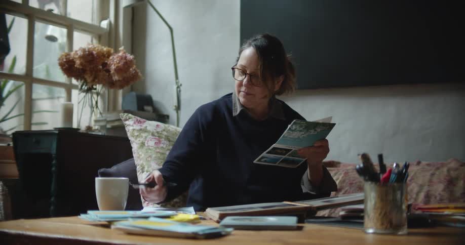 A woman takes notes while sitting on the couch