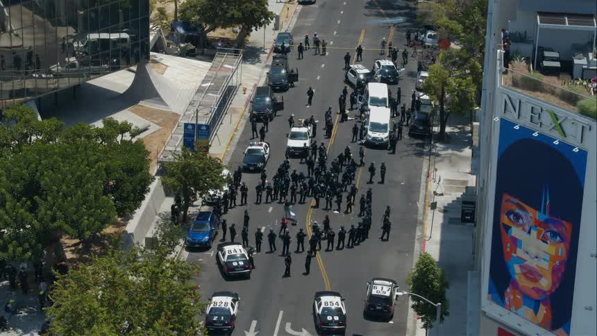 People are gathered in the middle of the street in the city