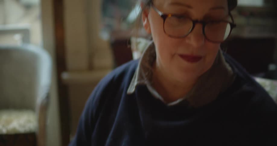 A woman sorting through photographs
