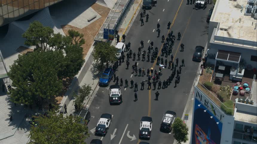 An aerial view of police officers surrounding a group of people