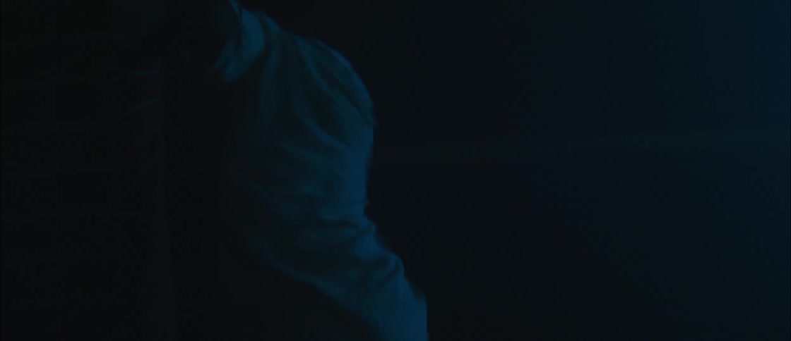 Silhouette of a young man dancing on a theatre under blue lights