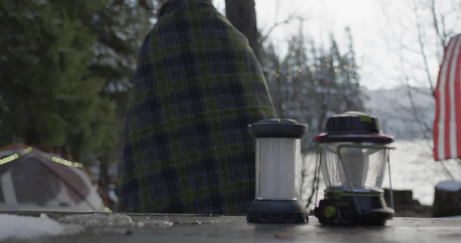 Two people camping near a river
